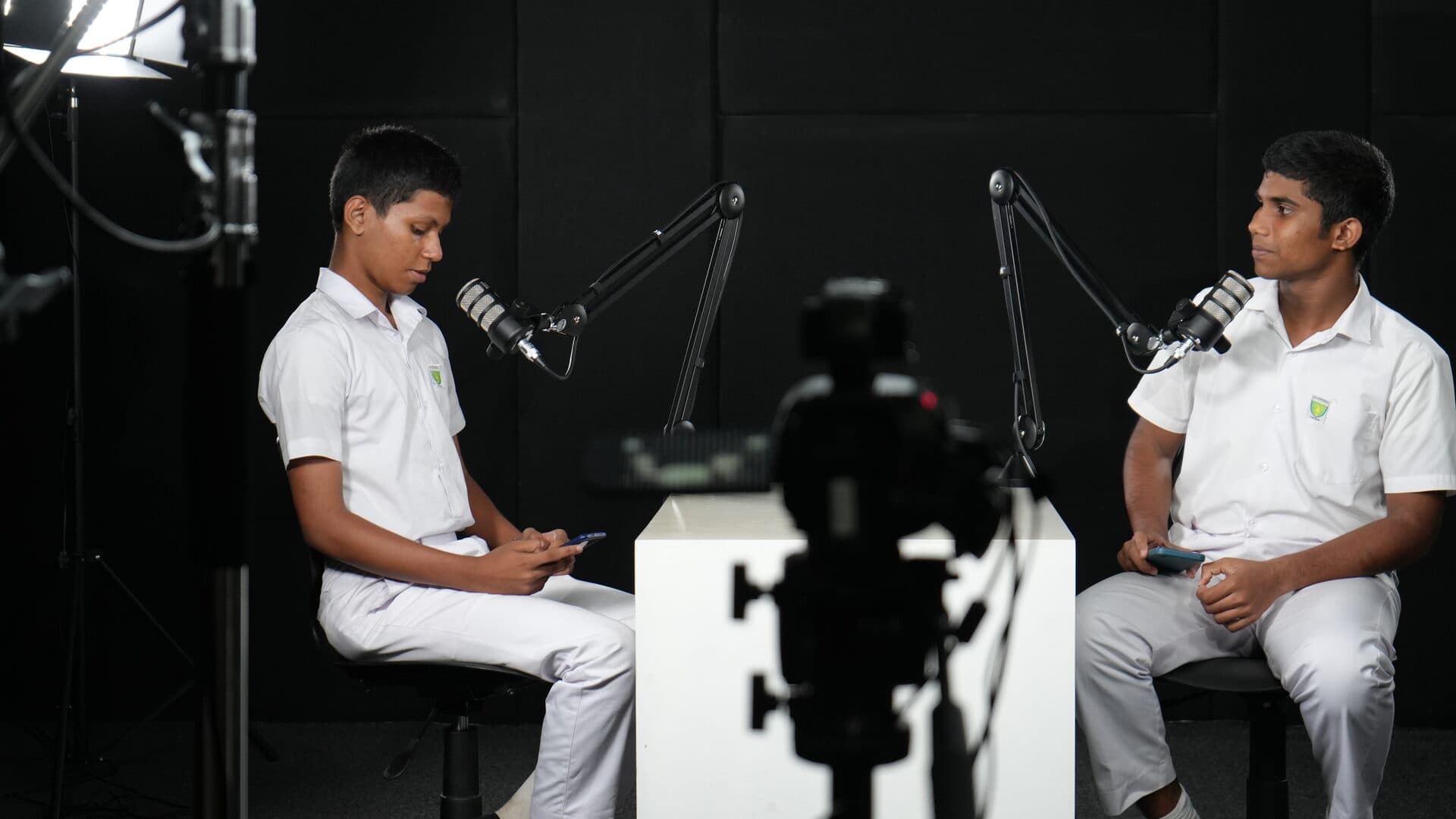 Two students conducting a podcast interview in the media studio