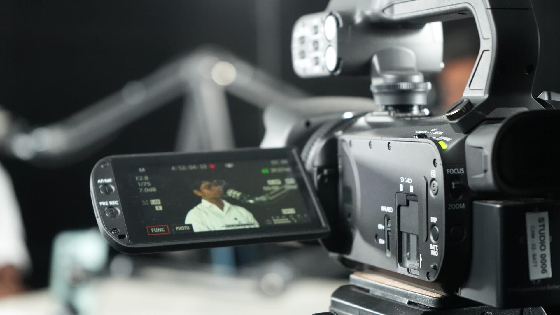 Close-up of a professional studio camera viewfinder capturing a student