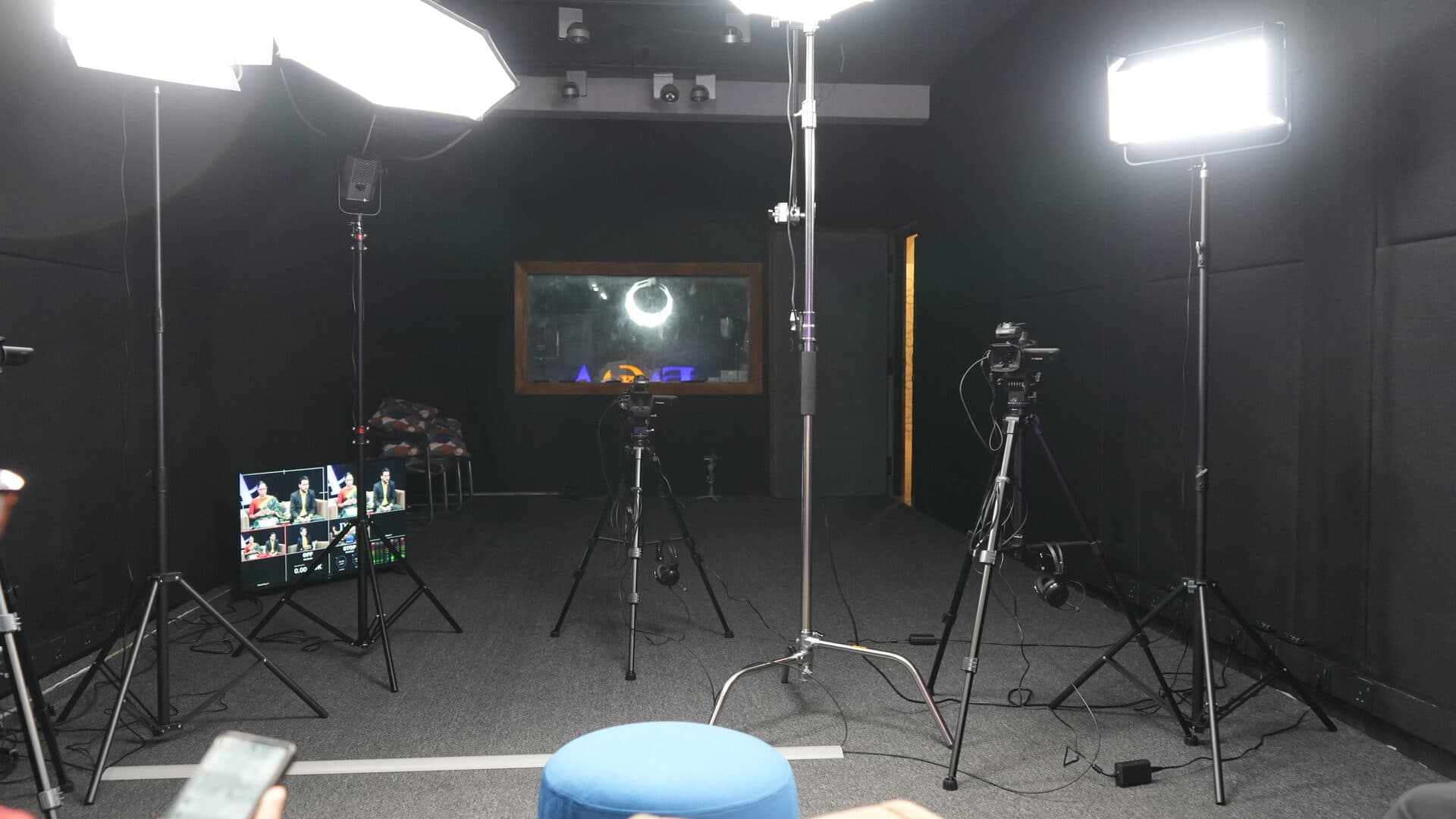 Professional cameras and lighting equipment set up in the media studio